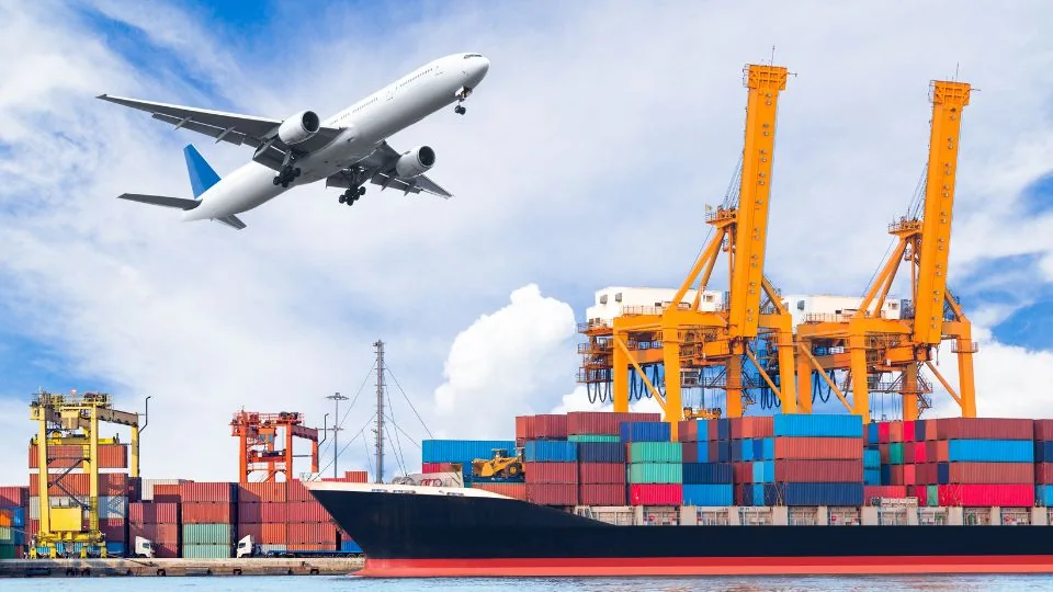 A cargo plane taking off above a container port